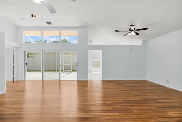 2045 SW Olympic Club Ter, Palm City, FL 34990 - unfurnished living room with a ceiling fan, high vaulted ceiling, wood finished floors, and baseboards