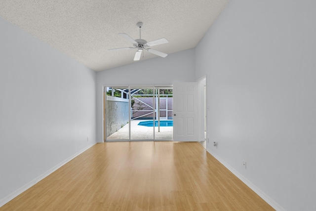 2281 SW Olympic Club Ter, Palm City, FL 34990 - unfurnished room featuring a textured ceiling, wood finished floors, ceiling fan, baseboards, and high vaulted ceiling