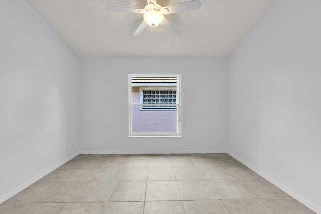 2281 SW Olympic Club Ter, Palm City, FL 34990 - unfurnished room featuring a textured ceiling, ceiling fan, light tile patterned floors, and baseboards