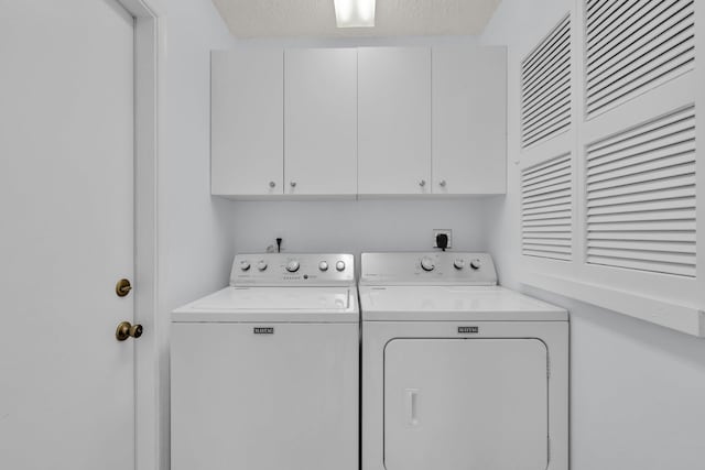 2281 SW Olympic Club Ter, Palm City, FL 34990 - laundry room featuring cabinet space and washing machine and clothes dryer