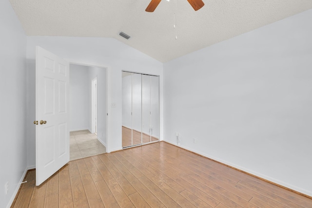 2281 SW Olympic Club Ter, Palm City, FL 34990 - unfurnished bedroom featuring lofted ceiling, a closet, wood finished floors, baseboards, and ceiling fan