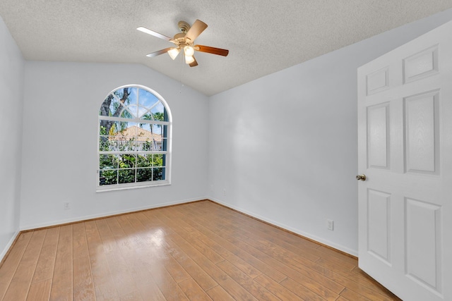 2281 SW Olympic Club Ter, Palm City, FL 34990 - unfurnished room with ceiling fan, lofted ceiling, wood finished floors, a textured ceiling, and baseboards