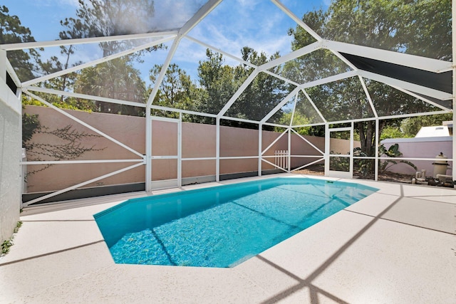 2281 SW Olympic Club Ter, Palm City, FL 34990 - view of pool with a patio area, a fenced backyard, and a lanai