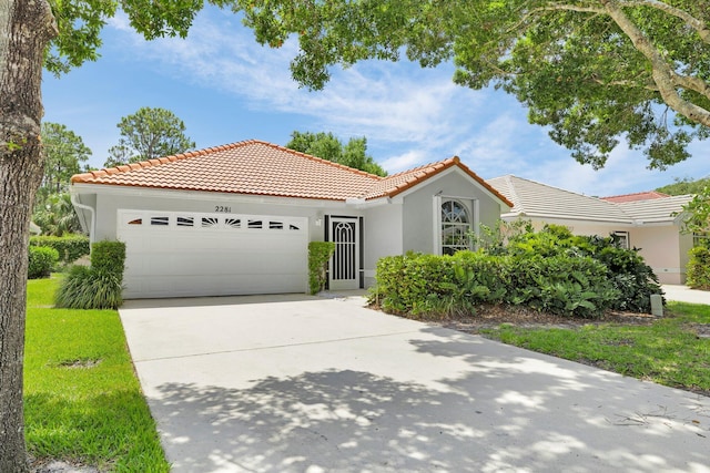 2281 SW Olympic Club Ter, Palm City, FL 34990 - mediterranean / spanish-style home with a tile roof, a garage, stucco siding, and driveway