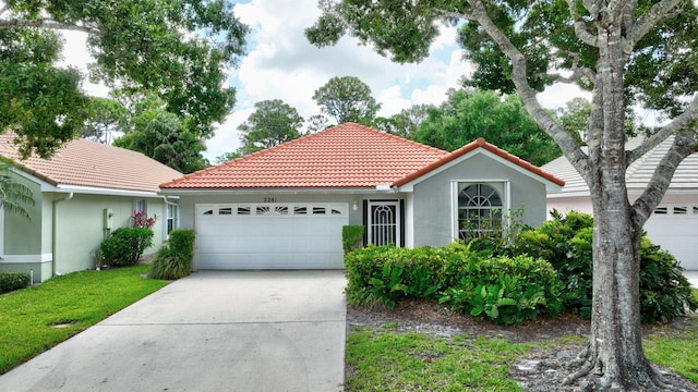 2281 SW Olympic Club Ter, Palm City, FL 34990 - mediterranean / spanish-style home with a garage, a tile roof, concrete driveway, and stucco siding