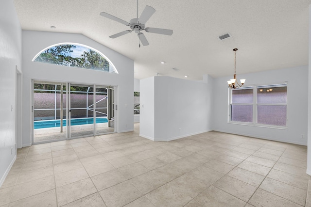 2281 SW Olympic Club Ter, Palm City, FL 34990 - spare room with a chandelier, a ceiling fan, tile patterned floors, a textured ceiling, and baseboards