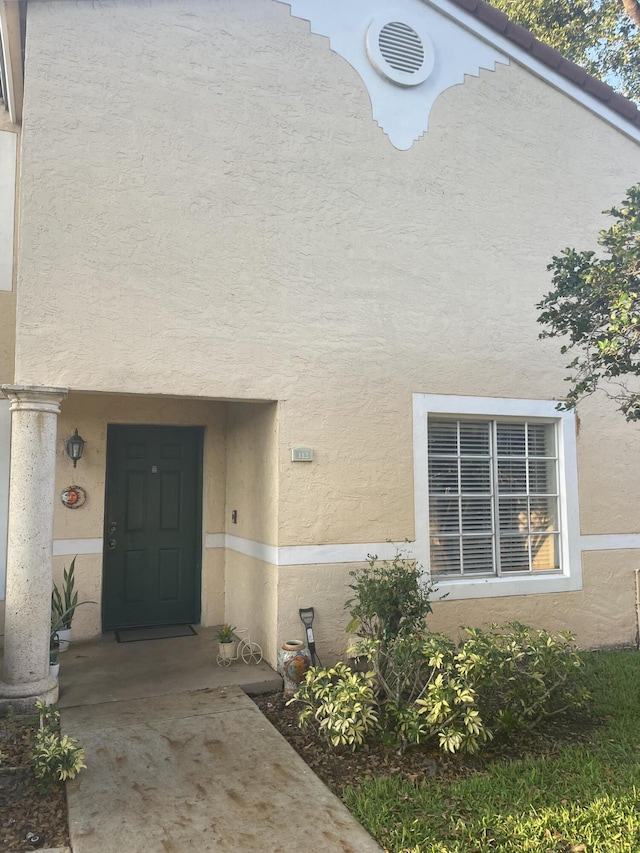 1701 Village Blvd Unit 112, West Palm Beach, FL 33409 - doorway to property with stucco siding