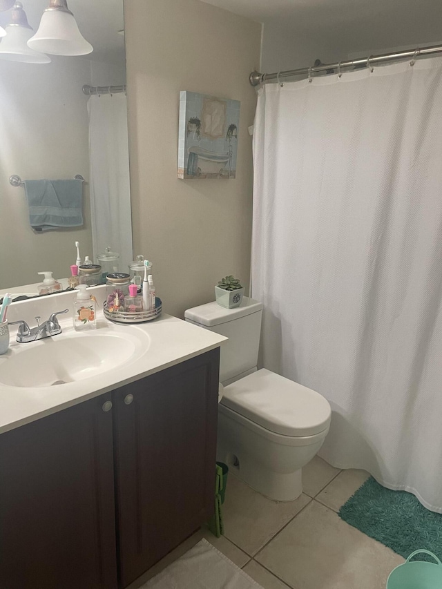 1701 Village Blvd Unit 112, West Palm Beach, FL 33409 - bathroom featuring vanity, tile patterned flooring, toilet, and a shower with shower curtain