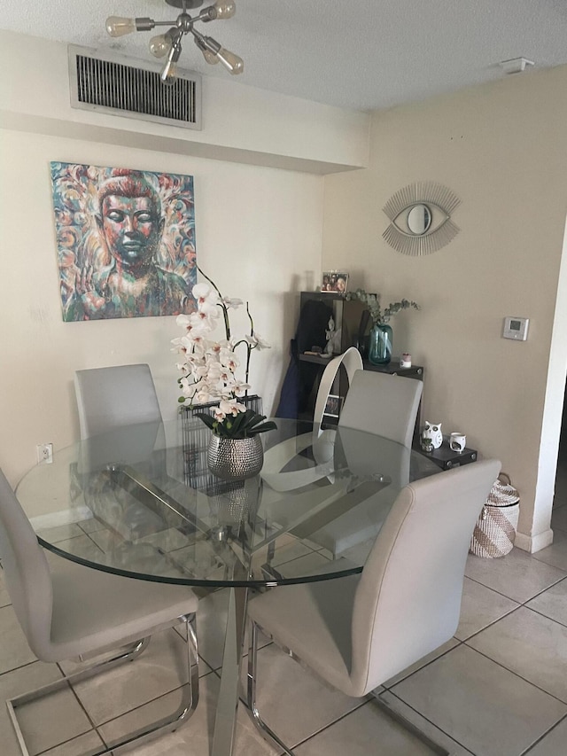 1701 Village Blvd Unit 112, West Palm Beach, FL 33409 - dining area featuring tile patterned floors, a textured ceiling, and baseboards
