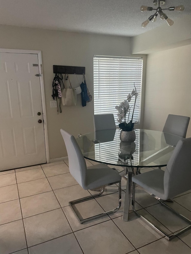 1701 Village Blvd Unit 112, West Palm Beach, FL 33409 - dining area with light tile patterned flooring, baseboards, and a textured ceiling