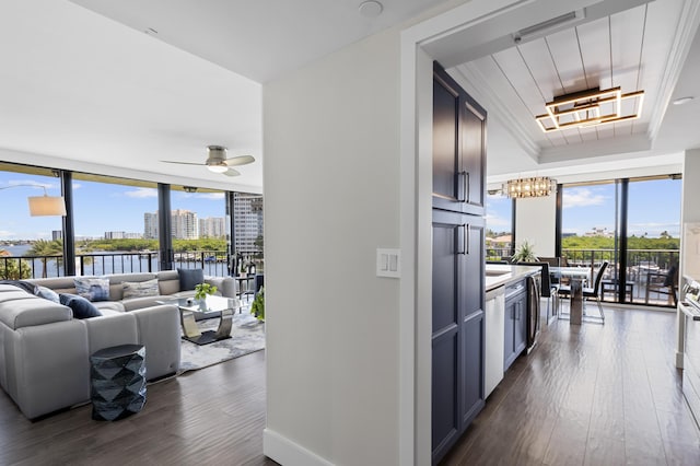899 Jeffery St Unit 414, Boca Raton, FL 33487 - kitchen featuring expansive windows, a chandelier, dark wood-type flooring, a tray ceiling, and light countertops