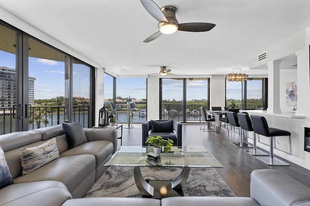 899 Jeffery St Unit 414, Boca Raton, FL 33487 - living area featuring dark wood-style flooring, a water view, ceiling fan, floor to ceiling windows, and a chandelier