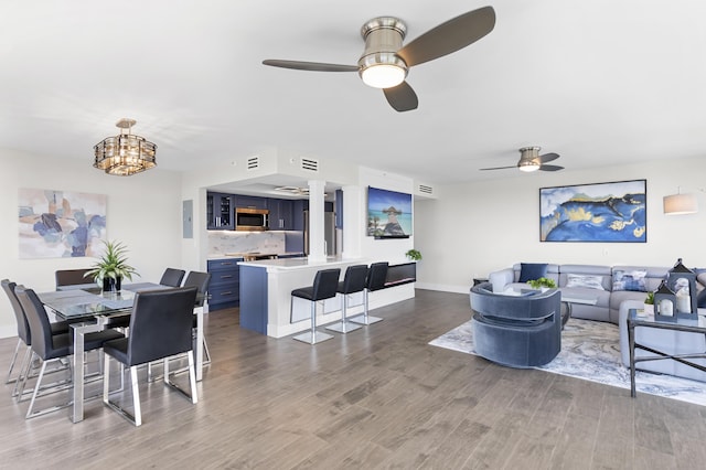 899 Jeffery St Unit 414, Boca Raton, FL 33487 - dining area with ceiling fan, wood finished floors, a chandelier, and baseboards