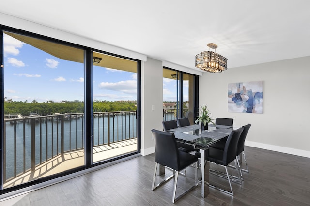 899 Jeffery St Unit 414, Boca Raton, FL 33487 - dining area featuring a chandelier, a water view, baseboards, and wood finished floors