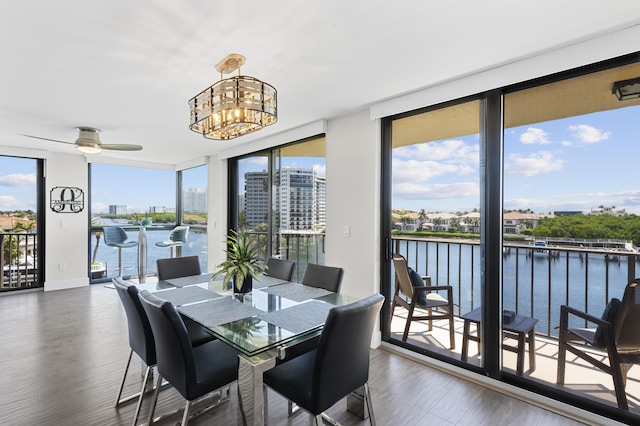 899 Jeffery St Unit 414, Boca Raton, FL 33487 - dining space with a wall of windows, dark wood-style flooring, a water view, a chandelier, and a ceiling fan