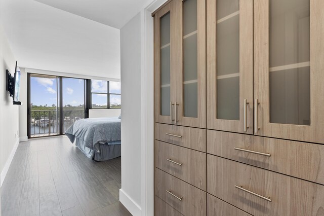 899 Jeffery St Unit 414, Boca Raton, FL 33487 - bedroom with baseboards, wood finished floors, and access to exterior