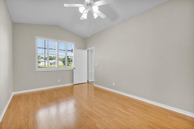 2274 SW Olympic Club Ter, Palm City, FL 34990 - unfurnished bedroom with light wood finished floors, vaulted ceiling, baseboards, and ceiling fan