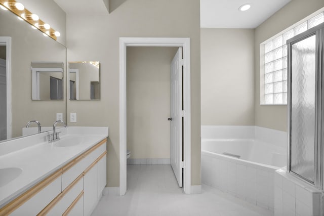 2274 SW Olympic Club Ter, Palm City, FL 34990 - full bathroom with a bath, double vanity, toilet, baseboards, and tile patterned flooring
