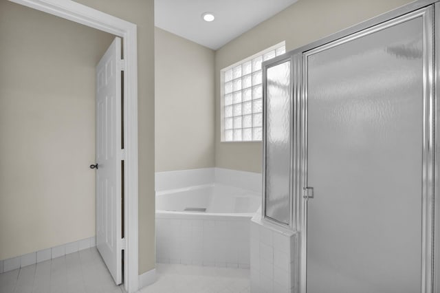 2274 SW Olympic Club Ter, Palm City, FL 34990 - full bathroom featuring a bath, a stall shower, tile patterned floors, and baseboards