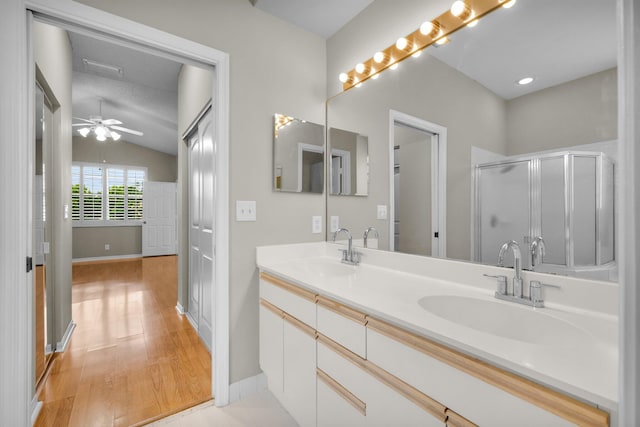 2274 SW Olympic Club Ter, Palm City, FL 34990 - bathroom with double vanity, vaulted ceiling, wood finished floors, an enclosed shower, and baseboards