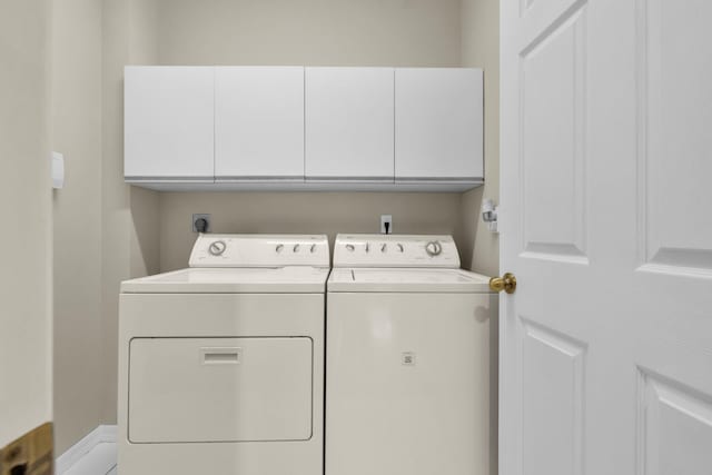 2274 SW Olympic Club Ter, Palm City, FL 34990 - laundry area with washer and clothes dryer and cabinet space