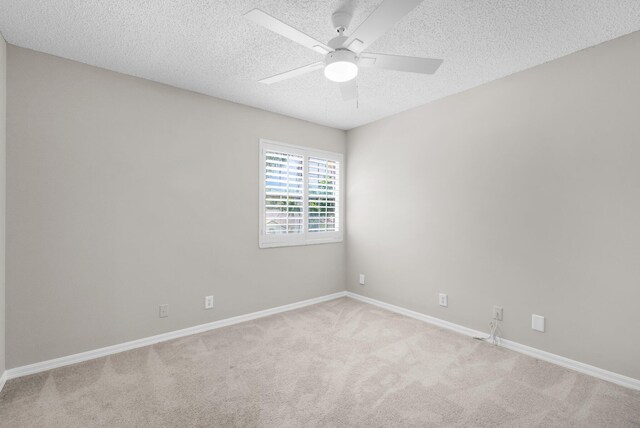 2274 SW Olympic Club Ter, Palm City, FL 34990 - unfurnished room featuring a textured ceiling, light colored carpet, a ceiling fan, and baseboards