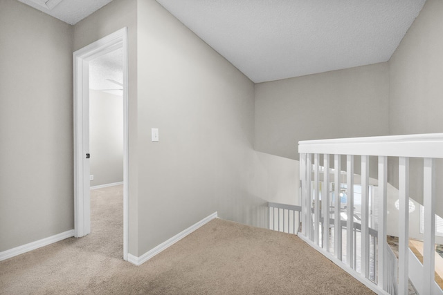 2274 SW Olympic Club Ter, Palm City, FL 34990 - hallway with carpet, baseboards, an upstairs landing, and a textured ceiling