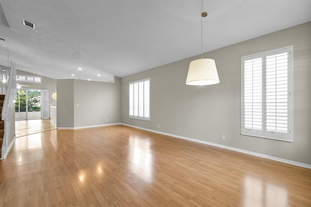 2274 SW Olympic Club Ter, Palm City, FL 34990 - spare room with light wood-style floors, baseboards, and lofted ceiling