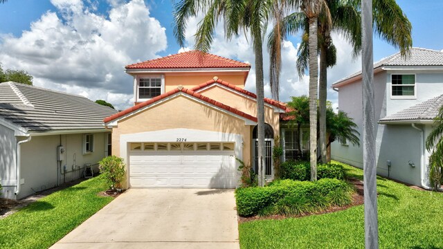 2274 SW Olympic Club Ter, Palm City, FL 34990 - mediterranean / spanish-style home with stucco siding, an attached garage, a tiled roof, driveway, and a front yard