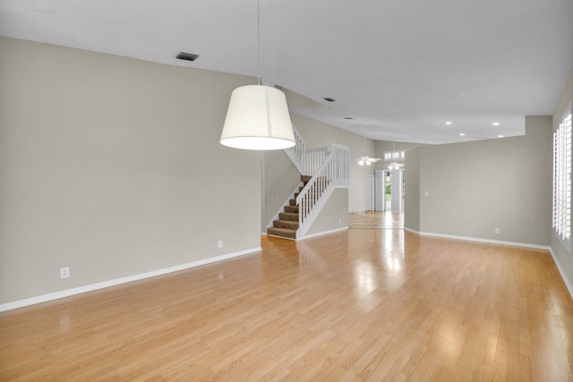 2274 SW Olympic Club Ter, Palm City, FL 34990 - empty room featuring stairs, light wood-type flooring, baseboards, and recessed lighting