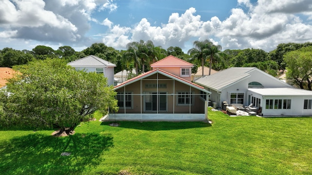 2274 SW Olympic Club Ter, Palm City, FL 34990 - rear view of property featuring a sunroom and a lawn