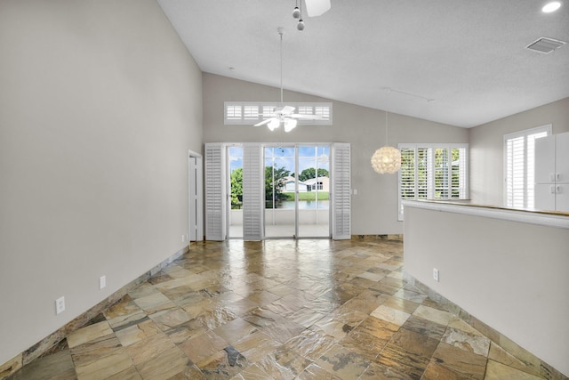 2274 SW Olympic Club Ter, Palm City, FL 34990 - unfurnished dining area with ceiling fan, vaulted ceiling, baseboards, plenty of natural light, and stone tile floors