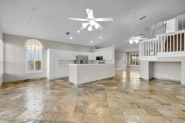 2274 SW Olympic Club Ter, Palm City, FL 34990 - kitchen featuring appliances with stainless steel finishes, open floor plan, ceiling fan, baseboards, and white cabinets