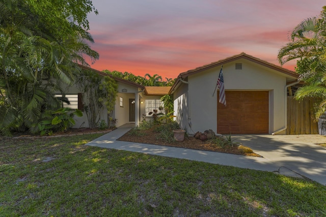 8858 SW 8th St, Boca Raton, FL 33433 - view of front of home with stucco siding, a garage, driveway, and a yard
