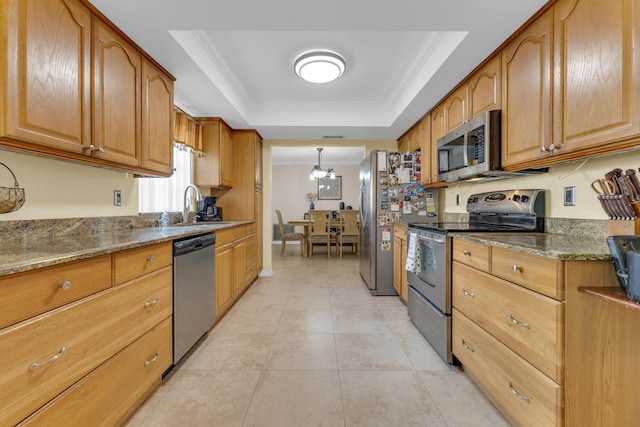 8858 SW 8th St, Boca Raton, FL 33433 - kitchen with stainless steel appliances, a raised ceiling, ornamental molding, light tile patterned floors, and brown cabinets