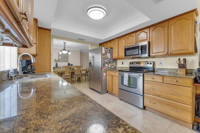 8858 SW 8th St, Boca Raton, FL 33433 - kitchen featuring appliances with stainless steel finishes, ornamental molding, a raised ceiling, dark stone counters, and a chandelier