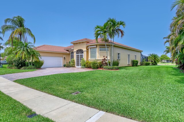 9466 Lantern Bay Cir, West Palm Beach, FL 33411 - mediterranean / spanish home with stucco siding, driveway, a front yard, and an attached garage
