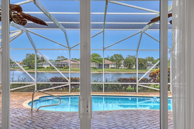 9466 Lantern Bay Cir, West Palm Beach, FL 33411 - outdoor pool featuring glass enclosure, a water view, and a patio