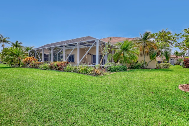 9466 Lantern Bay Cir, West Palm Beach, FL 33411 - back of house featuring a lawn, a lanai, and stucco siding