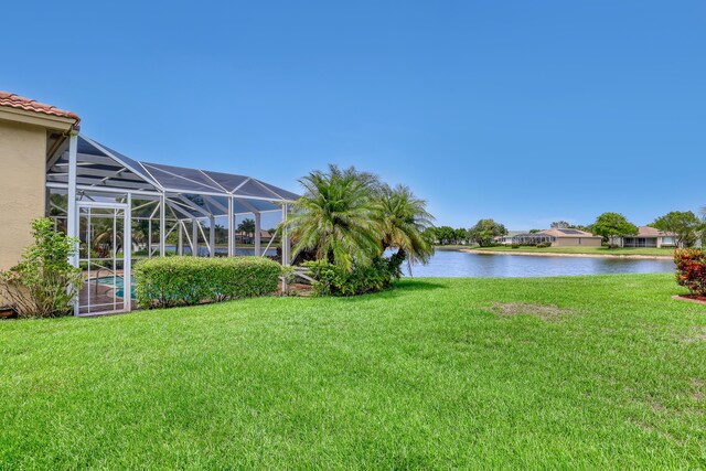 9466 Lantern Bay Cir, West Palm Beach, FL 33411 - view of green lawn with a water view and glass enclosure
