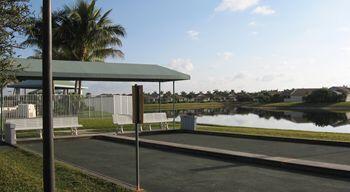 9466 Lantern Bay Cir, West Palm Beach, FL 33411 - dock area featuring a water view