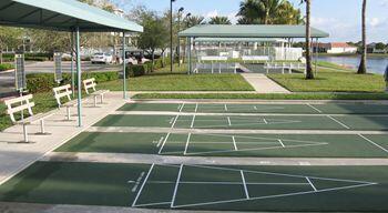 9466 Lantern Bay Cir, West Palm Beach, FL 33411 - surrounding community featuring a lawn, a water view, and shuffleboard