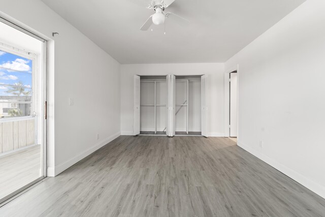 938 Normandy T 938, Delray Beach, FL 33484 - unfurnished bedroom featuring multiple closets, light wood-style floors, and baseboards