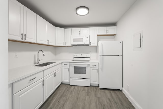 938 Normandy T 938, Delray Beach, FL 33484 - kitchen with white appliances, a sink, light wood-style flooring, and white cabinetry