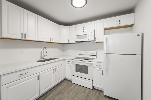 938 Normandy T 938, Delray Beach, FL 33484 - kitchen featuring white appliances, a sink, white cabinets, and light countertops