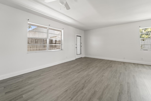 938 Normandy T 938, Delray Beach, FL 33484 - spare room featuring wood finished floors, a ceiling fan, and baseboards