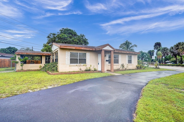4701 N Andrews Ave, Oakland Park, FL 33309 - single story home featuring stucco siding and asphalt driveway