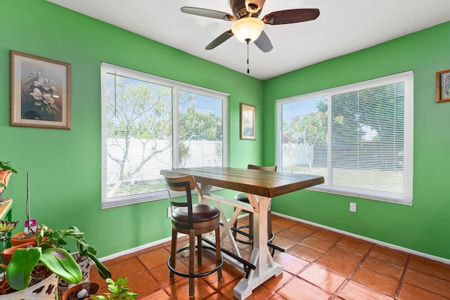 333 SE Dalva Ave, Port Saint Lucie, FL 34984 - tiled dining space with plenty of natural light, baseboards, and ceiling fan