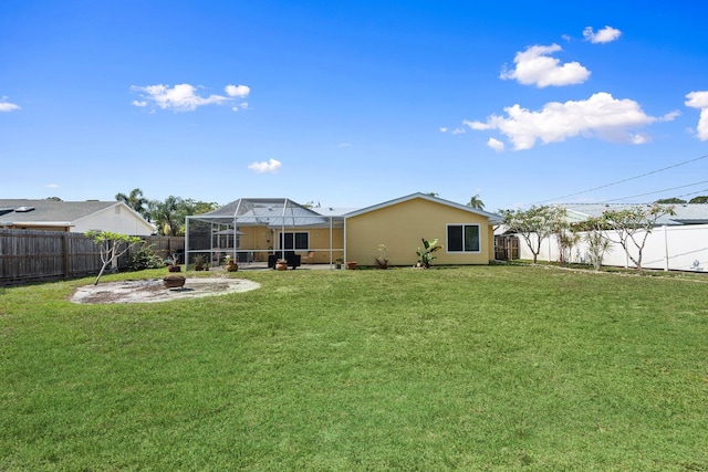 333 SE Dalva Ave, Port Saint Lucie, FL 34984 - back of house featuring glass enclosure, a patio area, and stucco siding
