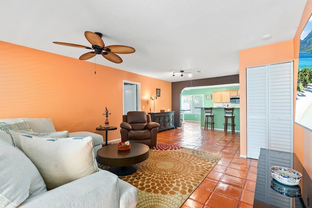 333 SE Dalva Ave, Port Saint Lucie, FL 34984 - living room with arched walkways, a ceiling fan, and light tile patterned flooring